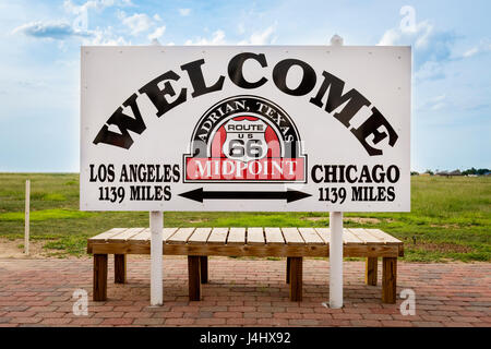 Adrian, Texas - July 9, 2014: Welcome sign marking the midpoint between Chicago and Los Angeles in the historic Route 66 in Adrian , Texas, USA. Stock Photo