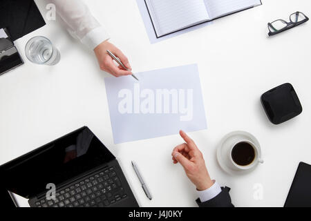Business People Discussing Over Document At White Desk Stock Photo