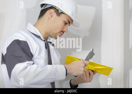 builder plastering cement on a wall Stock Photo