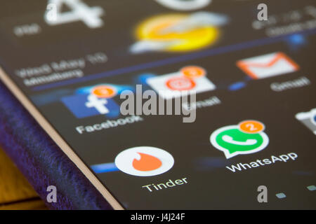 A closeup on a smartphone screen focused on the Tinder app Stock Photo