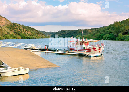 Portugal, Alentejo: Boat 'Vendaval' anchoring at quay of small riverside location Pomarao Stock Photo