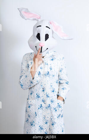 rabbit difficult to wake in the morning he is touching his nose dressing-up clothes and conceptual parody Stock Photo