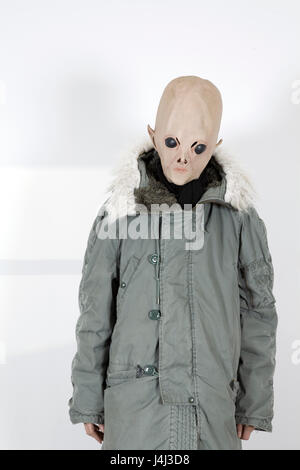 Alien wearing a military coat with hood fake fur Stock Photo