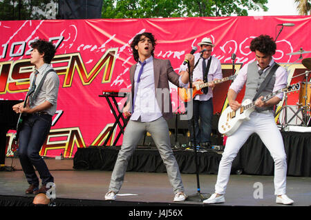 (L-R) Musicians Nick Jonas, Joe Jonas, and Kevin Jonas of The Jonas Brothers performing at the 2008 102.7 KISS FM Wango Tango Festival in Irvine. Stock Photo