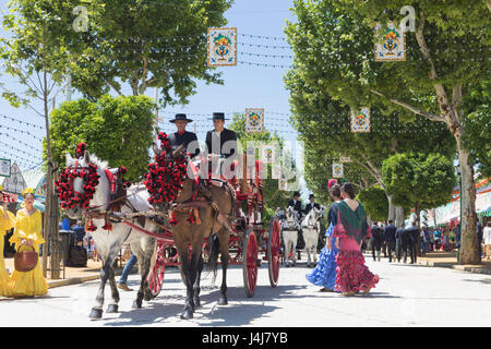 Seville, Seville Province, Andalusia, southern Spain.  Feria de Abril, the April Fair.  Horse and carriage parade. Stock Photo