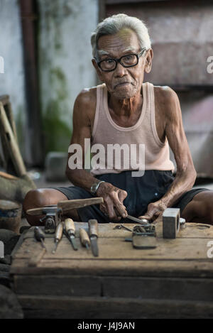 Senior Carpenter at work in his workshop in Yogyakarta, Java, Indonesia. Stock Photo