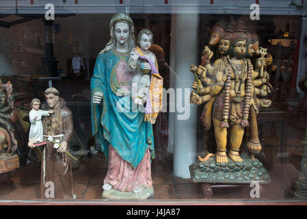 Fair sale of accessories for the decoration of churches: Catholic, Christian and Hindu sculptures of the gods together, Cochin, Kerala, South India. Stock Photo