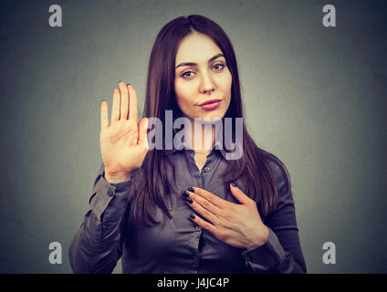 Woman making a promise or testifies Stock Photo