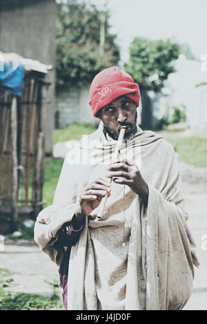 Ethiopian poor flute player playing flute on streets of Addis Ababa Ethiopia for earning livelihood Stock Photo