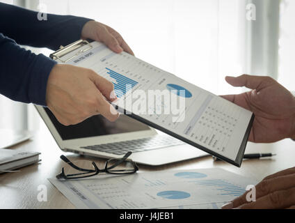 Financial analysts provide summary reports to manager. Stock Photo