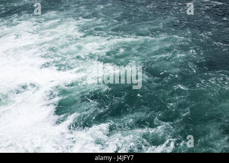 Stormy sea, waving deep blue water surface with foam, natural background photo