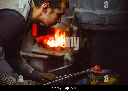 blacksmith working in the forge Stock Photo