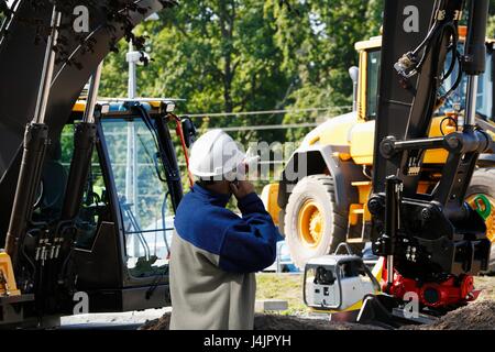 Engineer on phone on construction site. Stock Photo