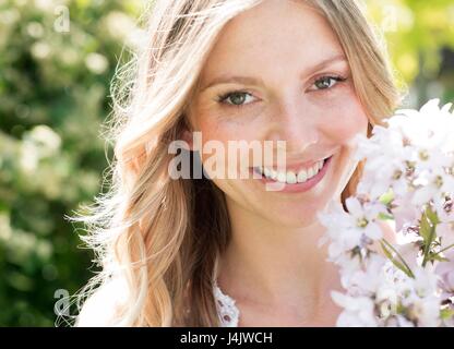 Young woman holding white flowers. Stock Photo