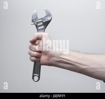 hand holding spanner tool Stock Photo