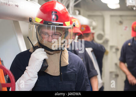 161104-N-NT265-013 PHILIPPINE SEA (Nov. 4, 2016) Petty Officer 3rd Class Jack Lang, assigned to the forward-deployed Arleigh Burke-class guided-missile destroyer USS McCampbell (DDG 85), passes dewatering progress via radio during a damage-control drill. McCampbell is on patrol in the Philippine Sea with Carrier Strike Group Five (CSG 5) supporting security and stability in the Indo-Asia-Pacific region. (U.S. Navy photo by Petty Officer 2nd Class Christian Senyk/Released) Stock Photo