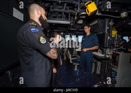 161113-N-DJ750-168 PACIFIC OCEAN (Nov. 13, 2016) – Seaman Matthew Reynolds gives Royal New Zealand Navy sailors a tour of the bridge of Arleigh Burke-class guided-missile destroyer USS Sampson (DDG 102). Sampson will report to U.S. Third Fleet, headquartered in San Diego, while deployed to the Western Pacific as part of the U.S. Pacific Fleet-led initiative to extend the command and control functions of Third Fleet into the region. (U.S. Navy photo by Petty Officer 2nd Class Bryan Jackson/Released) Stock Photo