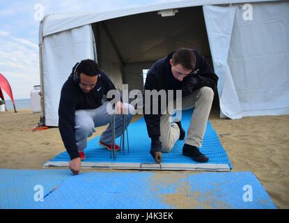 170202-N-YW501-026 VIRGINIA BEACH, Virginia (Feb. 2, 2017) Information Systems Technician 3rd Class John Broge, from Wyandotte, Michigan and Information Systems Technician 3rd Class Shandon Williams, from Atlanta, put together a ramp. Sailors assigned to the aircraft carrier USS George Washington (CVN 73) volunteered to set up for Polar Plunge 2017  in Virginia Beach. George Washington is homeported in Norfolk preparing to move to Newport News, Virginia for the ship’s refueling complex overhaul (RCOH) maintenance. (U.S. Navy photo by Mass Communication Specialist Seaman Jamin Gordon) Stock Photo