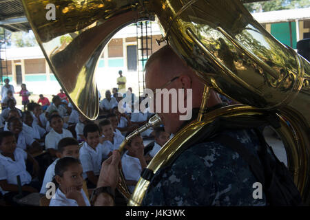 170227-N-WZ792-108 TRUJILLO, Honduras (Feb. 27, 2017) - Musician 1st Class Christopher Jerome, a native of Harrisonburg, Va., Assigned to U.S. Fleet Forces (USFF) Band, Norfolk Va., plays a sousaphone for host nation school children during a U.S. Band concert during Continuing Promise 2017 (CP-17) in Trujillo, Honduras.  CP-17 is a U.S. Southern Command-sponsored and U.S. Naval Forces Southern Command/U.S. 4th Fleet-conducted deployment to conduct civil-military operations including humanitarian assistance, training engagements, medical, dental, and veterinary support in an effort to show U.S. Stock Photo