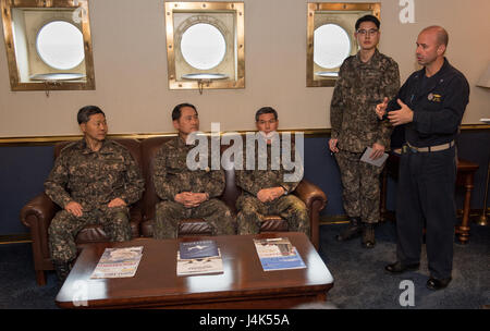 170320-N-BL637-129 WATERS EAST OF THE KOREAN PENINSULA (March 20, 2017) Rear Adm. Jim Kilby, commander, Carrier Strike Group 1, right, speaks to Gen. Jang, Jun Gyu, chief of staff of the Republic of Korea Army, left, Adm. Um, Hyun Seong, the Republic of Korea chief of naval operations, middle left, and Gen. Jeong, Kyeongdoo, chief of staff of the Republic of Korea Air Force, middle right, in the commanding officer’s in-port cabin aboard the aircraft carrier USS Carl Vinson (CVN 70). The Carl Vinson Carrier Strike Group is on a regularly scheduled Western Pacific deployment as part of the U.S.  Stock Photo