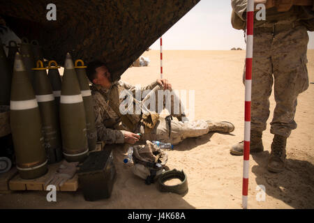 CAMP BUEHRING, Kuwait (April 23, 2017)— U.S. Marine Lance Cpl. Dustin Williams of Littleton, Colorado, a field artillery canon crewman assigned to Fox Battery, 3rd Battalion, 6th Marine Regiment, 24th Marine Expeditionary Unit (MEU) gets hit in the face with a wayward tarp at an indirect firing range outside Camp Buehring, Kuwait April 23, 2017. The Marines are in Kuwait for a sustainment training evolution.  The 24th MEU is currently deployed with the Bataan Amphibious Ready Group in support of maritime security operations designed to reassure allies and partners and preserve the freedom of n Stock Photo