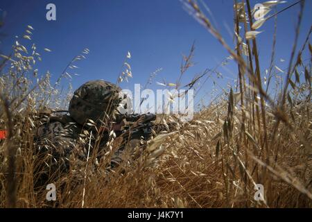 SAN CLEMENTE ISLAND, Calif. - Lance Cpl. Edwin Kramer, a rifleman, provides perimeter security as fellow Marines finish clearing the target objective during a mechanized assault as part of Composite Training Unit Exercise, May 4, 2017. COMPTUEX is the second at-sea training period for the America Amphibious Ready Group and the 15th Marine Expeditionary Unit. The AARG and 15th MEU train as they fight; this exercise allows the building and refinement of the Blue-Green Team as they to work closely to plan and execute critical missions to prepare them for anything that may arise during their upcom Stock Photo