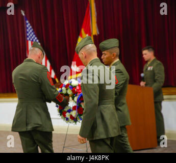 Sgt. Maj. Michael P. Woods (Left) and Maj. Gen.  John K. Love (Middle) prepare memorial wreaths to honor those who has fallen during Exercise Purple Star, at Camp Lejeune, N.C., May 5th, 2017. Marines conducted the Purple Star Memorial to honor the fallen Marines and Sailors of Exercise Purple Star. The Marines are with 2nd Battalion, 8th Marine Regiment, 2nd Marine Division. (U.S. Marine photo by Lance Cpl. Leynard Kyle Plazo) Stock Photo