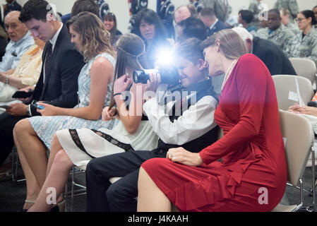 Christopher Manion, son of Col. Michael Manion, 403rd Wing commander takes a photo during his father's retirement ceremony May 7, 2017 at Keesler Air Force Base, Mississippi. (U.S. Air Force photo/Staff Sgt. Heather Heiney) Stock Photo