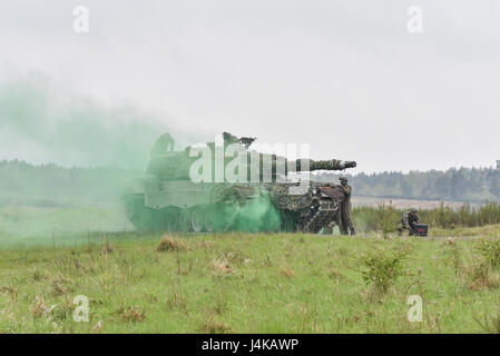 Austrian soldiers with the Bundesheer platoon, react to a simulated improved explosive device, during the Strong Europe Tank Challenge (SETC), at the 7th Army Training Command Grafenwoehr Training Area, Grafenwoehr, Germany, May 8, 2017. The  Strong Europe Tank Challenge (SETC) is co-hosted by U.S. Army Europe and the German Army, May 7-12, 2017. The competition is designed to project a dynamic presence, foster military partnership, promote interoperability, and provides an environment for sharing tactics, techniques and procedures. Platoons from six NATO and partner nations are in the competi Stock Photo