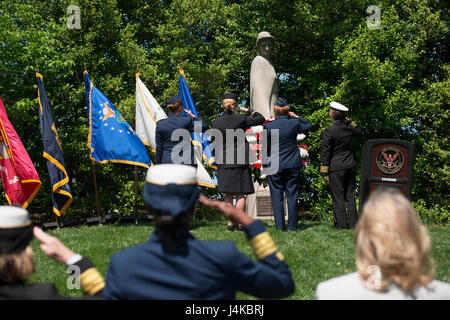 Col. Maggie Jones, deputy chief of nurses, Air Force, Col. Sandra McNaughton, senior nurse analyst, Defense Health Agency, Maj. Gen. Dorothy Hogg, deputy surgeon general and chief, Air Nurse Corps, and Capt. Deborah Roy, deputy chief of nurses, Navy, salute the Nurses Memorial during a wreath laying ceremony at Arlington National Cemetery in Virginia for National Nurses Week, May 8, 2017. Erected in 1938, the granite statue honors the nurses who served in the U.S. armed forces in World War I.  (U.S. Army photo by Elizabeth Fraser/Arlington National Cemetery/Released) Stock Photo