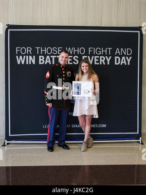 U.S. Marine Sgt. Roderick Evans presents Natasha Kusibab and her mentor ...