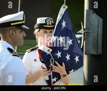 Lt. jg. Tigran Sadoian and Lt. jg. Caylin Schultz, nurses, perform morning colors during a ceremony celebrating Nurses Week, May 10, 2017. NHCL Officers, Sailors and Civilians gathered in formation to observe the ceremony. (U.S. Navy Photo by Mass Communication Specialist 3rd Class Nicolas N. Lopez/ Released) Stock Photo