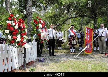 The British War Grave Ceremony comes to an end as local student Enrique Babilonia play 'Last Post,' a British military bugle call, in Buxton, N.C., on Thursday, May 11, 2017. The ceremony marks the 75th anniversary commemorating the loss of British and Canadian sailors from the HMS Bedfordshire and the British merchant vessel San Delfino following a German submarine attack. (U.S. Coast Guard photo by Petty Officer 3rd Class Corrie Smith) Stock Photo