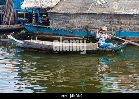 SIEM REAP, CAMBODIA-NOVEMBER 17, 2011: An unidentified girl on a boat floating on Tonle Sap lake in Siem Reap. Tonle Sap is the largest lake in SE Asi Stock Photo