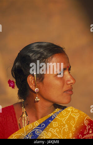 Young South Indian model in bridal red sari with golden jewelry set