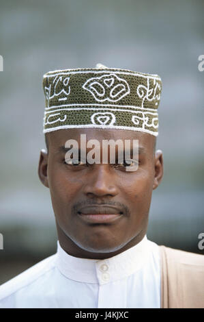 The Comoro Archipelago, island Anjouan, Mutsamudu, man, young, cap, portrait no model release! Africa, Indian ocean, island state, Nzwani, man's portrait, young, non-white, swarthy, swarthy, local, headgear, traditionally, tradition, faith, religion, religiously, Moslem, Islamic, Islam, view camera Stock Photo