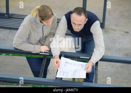 female worker and architect watching some details on a construction Stock Photo