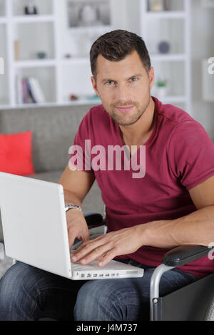 portrait of smart disabled businessman using laptop Stock Photo - Alamy