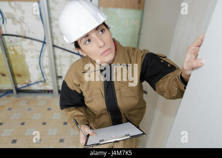 female engineer studying building wall Stock Photo