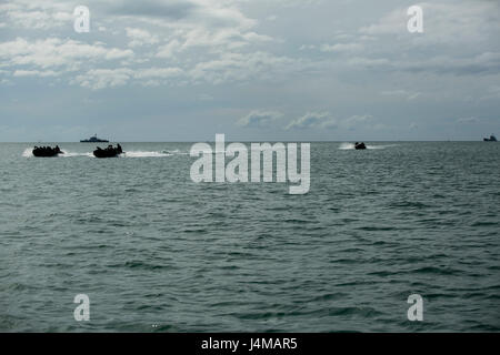 U.S. Marines and Royal Cambodian Navy Sailors operate Combat Rubber Reconnaissance Craft (CRRC) ahead of a Landing Craft Utility (LCU) from Ream Naval Base, Sihanoukville, Cambodia, Nov. 3, 2016. The Marines and Sailors participated in a culminating event which incorporates amphibious landing, medical treatment and water purification during Cooperation Afloat Readiness and Training (CARAT) 16. CARAT 2016 is a nine-country, bilateral exercise series between the United States and Bangladesh, Brunei, Cambodia, Indonesia, Malaysia, Singapore, the Philippines, Thailand, and Timor-Leste. This phase  Stock Photo