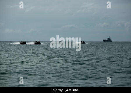 U.S. Marines and Royal Cambodian Navy Sailors operate Combat Rubber Reconnaissance Craft (CRRC) ahead of a Landing Craft Utility (LCU) from Ream Naval Base, Sihanoukville, Cambodia, Nov. 3, 2016. The Marines and Sailors participated in a culminating event which incorporates amphibious landing, medical treatment and water purification during Cooperation Afloat Readiness and Training (CARAT) 16. CARAT 2016 is a nine-country, bilateral exercise series between the United States and Bangladesh, Brunei, Cambodia, Indonesia, Malaysia, Singapore, the Philippines, Thailand, and Timor-Leste. This phase  Stock Photo