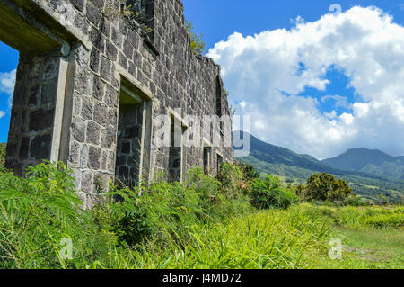 what is left of a thick house wall made of stones in the mountains Stock Photo