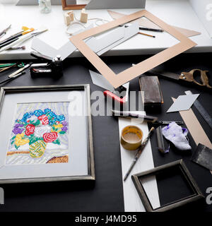 Picture frame and tools on table Stock Photo