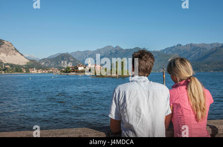 Caucasian couple admiring scenic view of lake Stock Photo