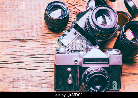 Cameras and lenses on wooden table Stock Photo