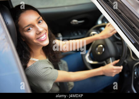 View from sunroof of Hispanic woman driving car Stock Photo