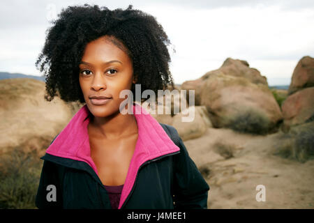 Portrait of serious Black woman posing on rock formation Stock Photo
