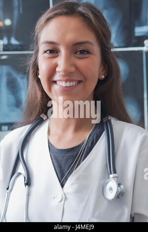 Portrait of smiling Hispanic doctor Stock Photo