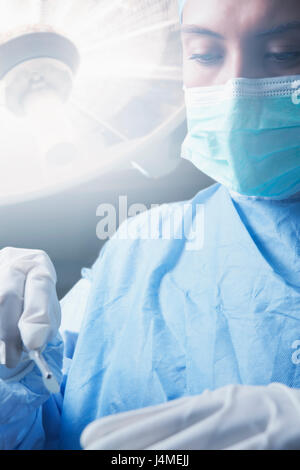 Hispanic surgeon holding scalpel Stock Photo