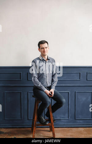 Portrait of Middle Eastern man sitting on stool Stock Photo